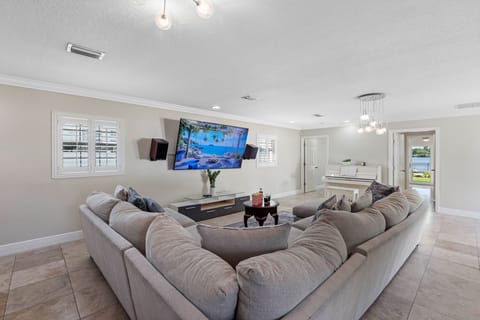 At the center of the room is a large smart TV, equipped with access to popular streaming platforms.