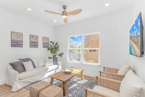 Sunny living space with comfortable seating and modern coastal decor