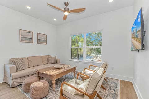 Comfortable living area with seating, TV, and bright windows