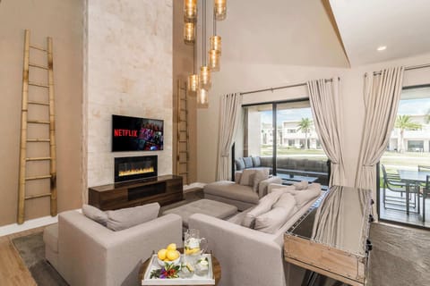 Open living space with Smart TV, fireplace, and patio access