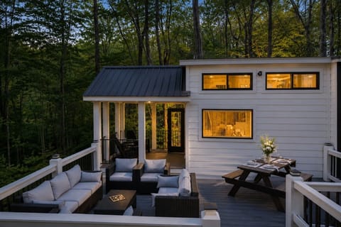 Spacious private deck with outdoor lounge seating, dining area, and peaceful forest views—perfect for morning coffee, evening conversations, or simply unwinding in the North Georgia mountains.