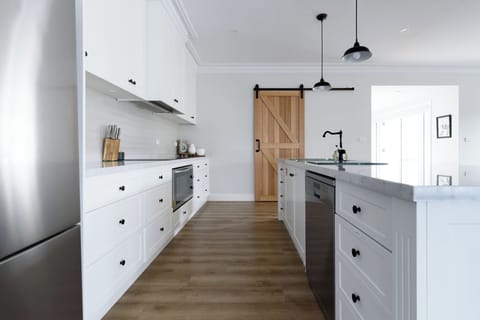 Crisp white cabinetry and barn door charm
