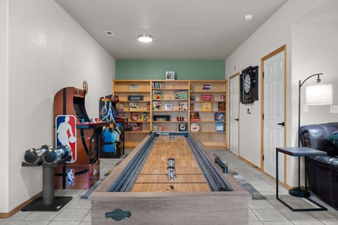 Game on! This room features shuffleboard, arcade classics, cozy seating, and a Smart TV for endless entertainment.