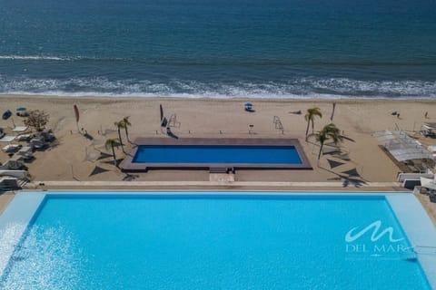 Shared oceanfront pool overlooking the beach, perfect for cooling off after a day in the sun