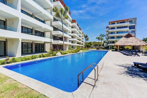 Shared outdoor pool w/ easy access steps, perfect for relaxing swims under the sun