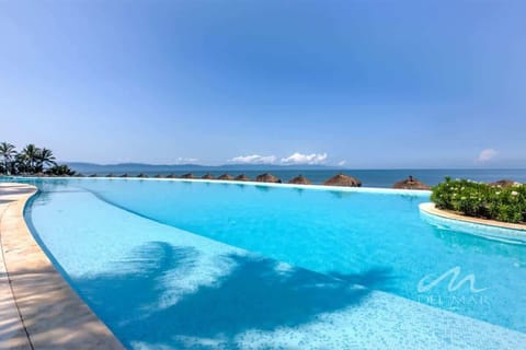 Shared Infinity-edge pool overlooking the ocean, perfect for cooling off while soaking in sweeping coastal views
