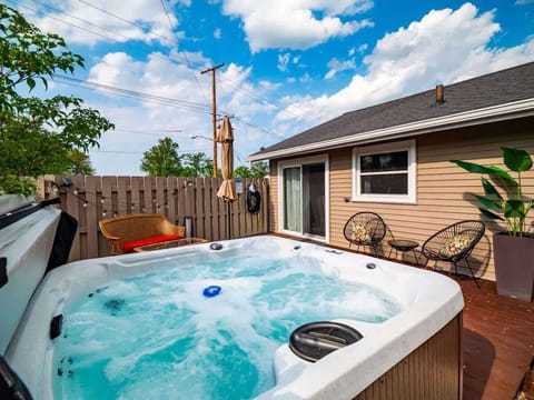 Relax in style on the private back deck—complete with a bubbling hot tub, cozy wicker seating, and room to soak up the sun or stargaze at night! 