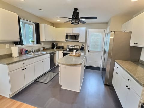 Our kitchen includes: Electric stove, microwave, fridge/freezer and prep space.