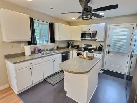 Our kitchen includes: Electric stove, microwave, fridge/freezer and prep space.