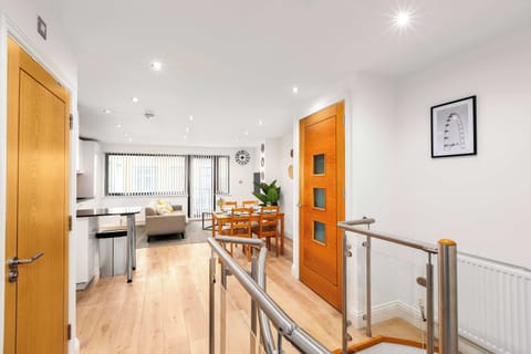 Step through the welcoming entrance into a bright open-plan living, kitchen and dining area, filled with natural daylight to create a warm and inviting atmosphere
