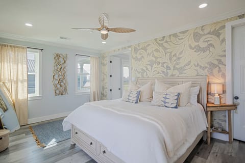 Third floor Primary Suite with king bed, deck access and en-suite bath.