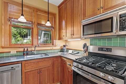 Your fully equipped kitchen features warm wood cabinetry, granite counters, and stainless appliances for creating memorable meals together.