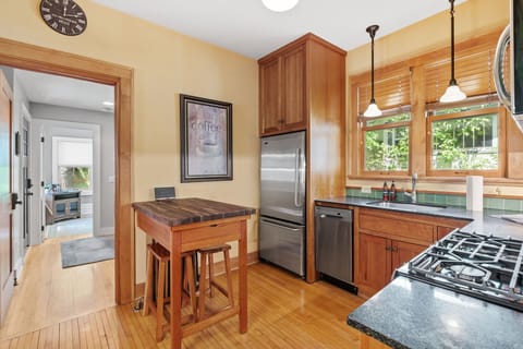 Cook your favorite meals in this charming kitchen with warm wood cabinetry, granite counters, and modern appliances.