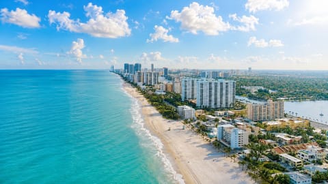 Coastal view with tall buildings and calm turquoise water