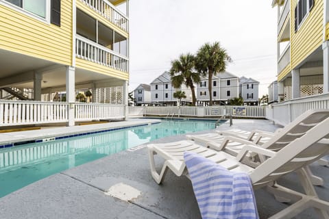 Take a dip in the seasonal outdoor pool surrounded by palm trees, offering a serene atmosphere for family fun and relaxation.