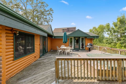 Spacious wooden deck with outdoor seating and umbrella, perfect for relaxing in the fresh air.
