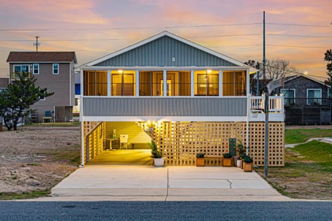Charming beach house with a spacious screened-in porch and inviting coastal design.  