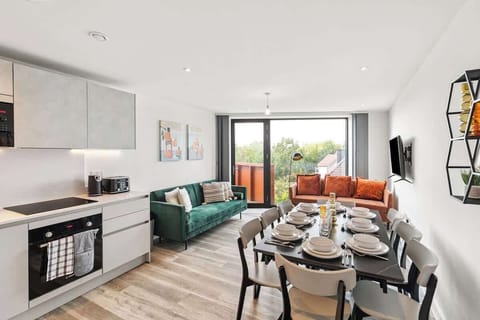 - Bright open-plan living with modern sofa seating and smart TV  
- Dining table set for group meals perfect for family stays  
- Balcony access and natural light enhance apartment comfort  
