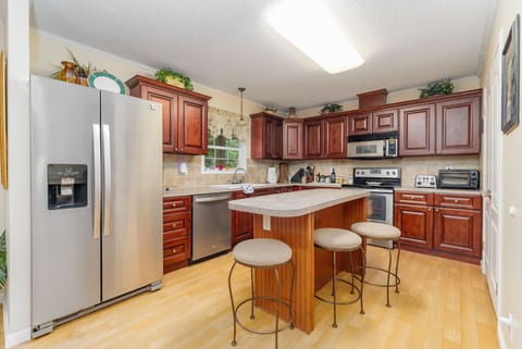 Cook up a storm in this sleek space with modern appliances and island seating!