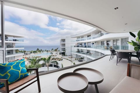 Relax in style on your expansive private balcony, featuring contemporary outdoor seating and sweeping views of the resort`s sparkling pool and the turquoise Caribbean Sea.