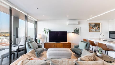 This chic, sunlit living area effortlessly blends modern style with a warm and inviting atmosphere.