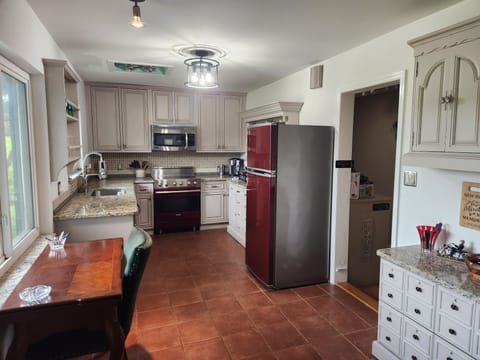 Well-appointed kitchen with lake views, antique desk, with Viking appliances