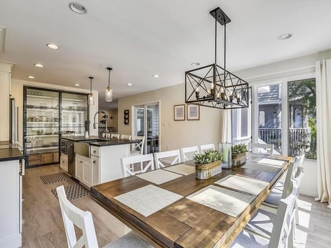 The open-plan kitchen and dining area showcases elegant furnishings, a large dining table, and a modern culinary space equipped with a stylish island and smart appliances for entertaining.
