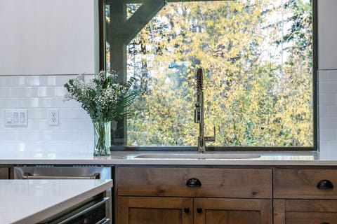 Open concept kitchen with stainless steel appliances and granite countertops