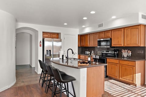 Spacious kitchen with island seating and modern appliances—perfect for cooking and gathering.
