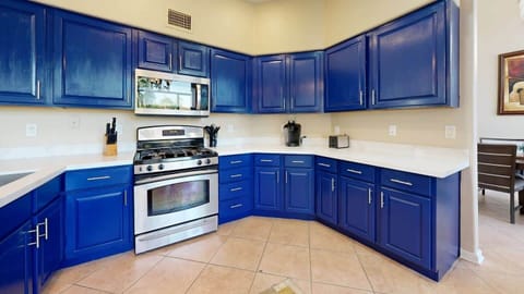 Where every meal is a masterpiece – high-end appliances meet stunning blue cabinetry.