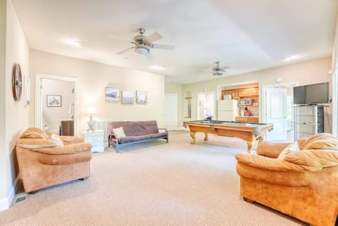 Lower-level lounge with pool table, sectional sofa, and TV—gather for games and movies.