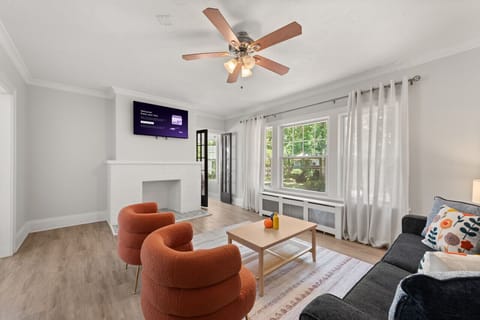 Bright and welcoming living room with a decorative fireplace, Smart TV, and comfortable seating—the perfect place to relax after a day exploring Cleveland.