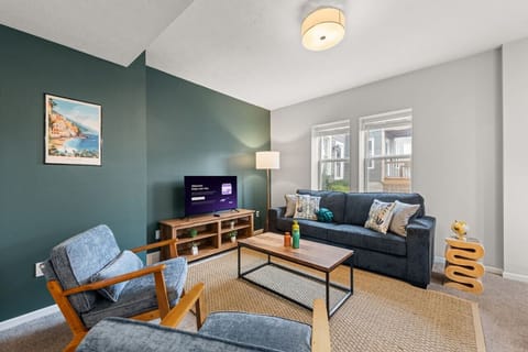 Gather together in the open living room, where comfortable seating and a large Smart TV make it easy to relax and reconnect.