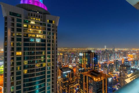 Skyline View: Marvel at Dubai`s dazzling lights from this stunning balcony vantage point!