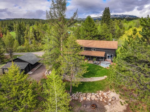 Front of the home with a large fenced yard and hot tub