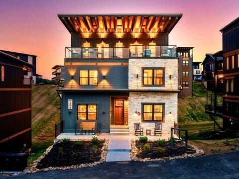 Side-angle rooftop shot at dusk with glowing lights.