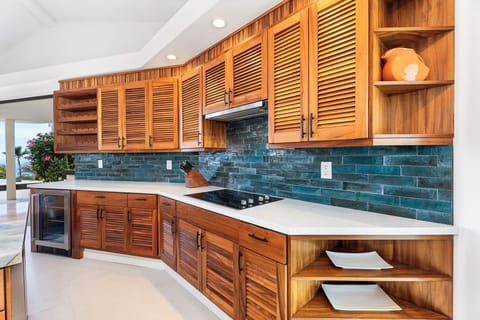 Elegant coastal kitchen stocked for home-cooked feasts, where form meets function with sleek finishes and thoughtful storage.