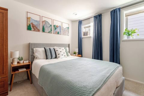 Comfy queen bed with room darkening curtains, soft lighting, cotton sheets.