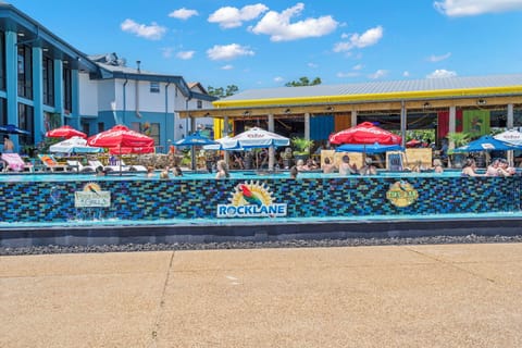 The ultimate poolside scene! Float, sip, and mingle at Rock Lane's lively infinity pool — with the Rock Island Tiki Bar and Grill just steps away for the perfect lakeside party vibe.