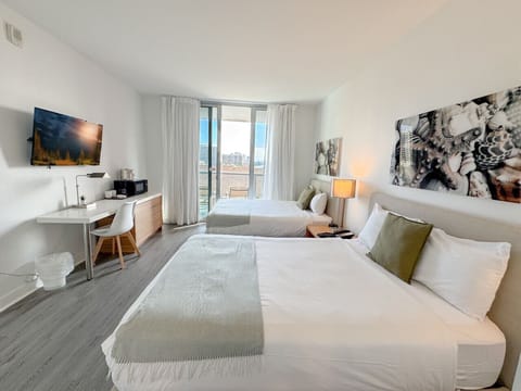 Bright room with two comfortable beds and outdoor views.