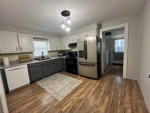Kitchen with electric range and oven, full refrigerator, dishwasher, air fryer