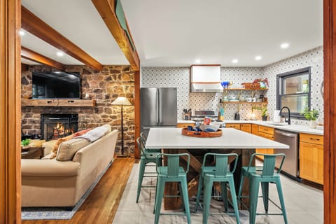 Eat-in kitchen area with island seating and wood-beamed ceilings.
