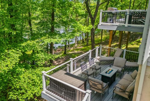 Balcony with cozy seating and forest views.