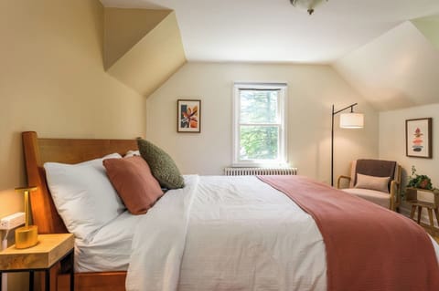 The spacious primary bedroom features a plush king bed, blackout shades, and soft lighting for a restful night’s sleep - whether you're turning in early or sleeping in late.