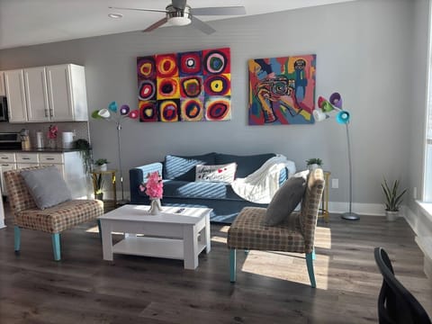 Living Room: Vibrant art and playful decor invite relaxation and fun in this airy space!