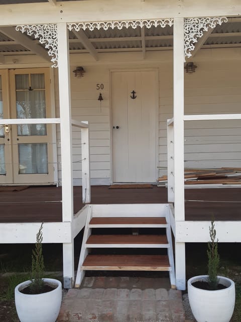 Pretty front verandah to sit and watch the sunrise over the river.