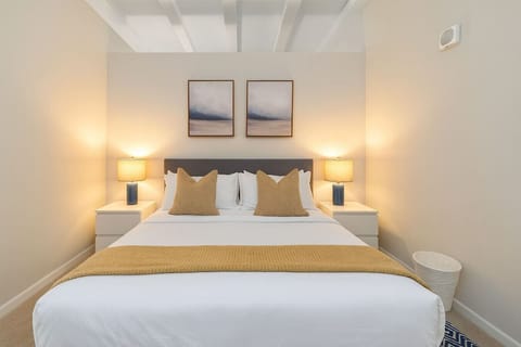 The room’s soft lighting and comfortable queen bed create a serene space perfect for relaxation and restful nights.