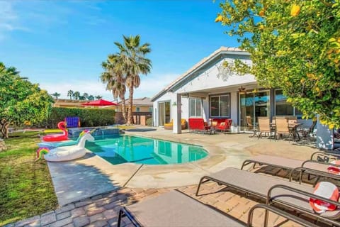 Soak up the sun in your private backyard oasis, complete with a sparkling pool, hot tub, lounge chairs, and fun floaties — the perfect setup for a relaxing getaway!