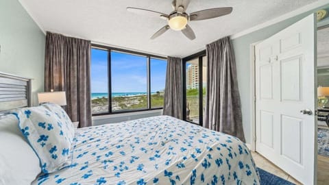 Wake up to stunning Gulf views in a cozy bedroom with a queen bed and private balcony access.