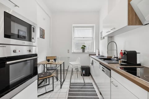 Helle Küche mit moderner Ausstattung, Essplatz und Kinderhochstuhl.